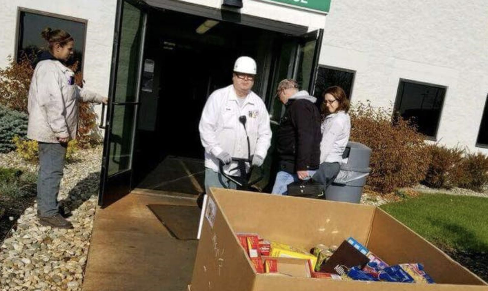 ACM worker pulling a box of non-perishable items