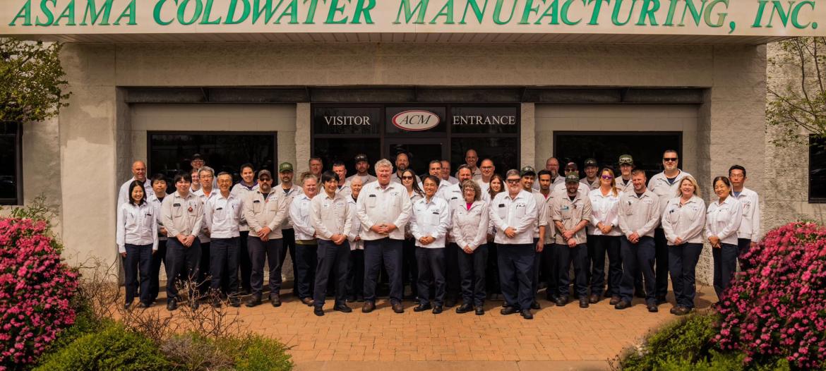 ACM workers posed in front of the ACM building