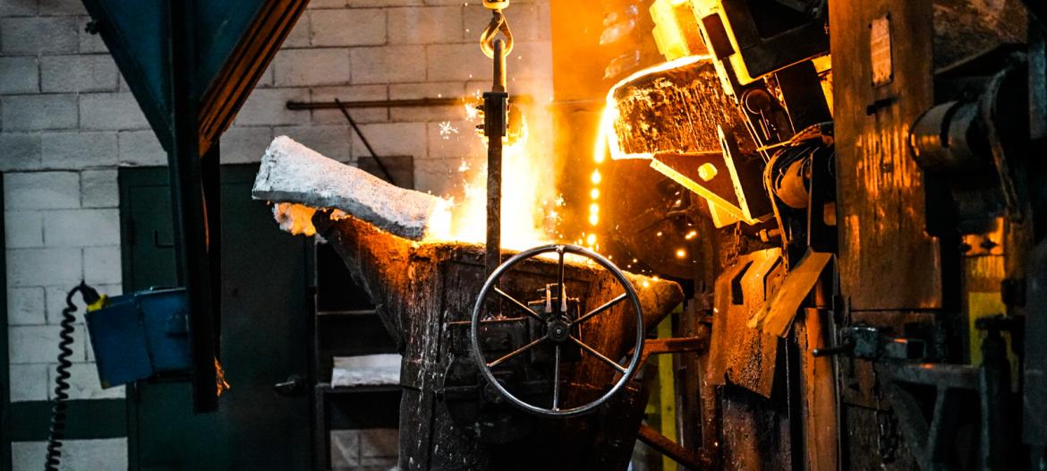 A metal bucket with a fire coming out of it